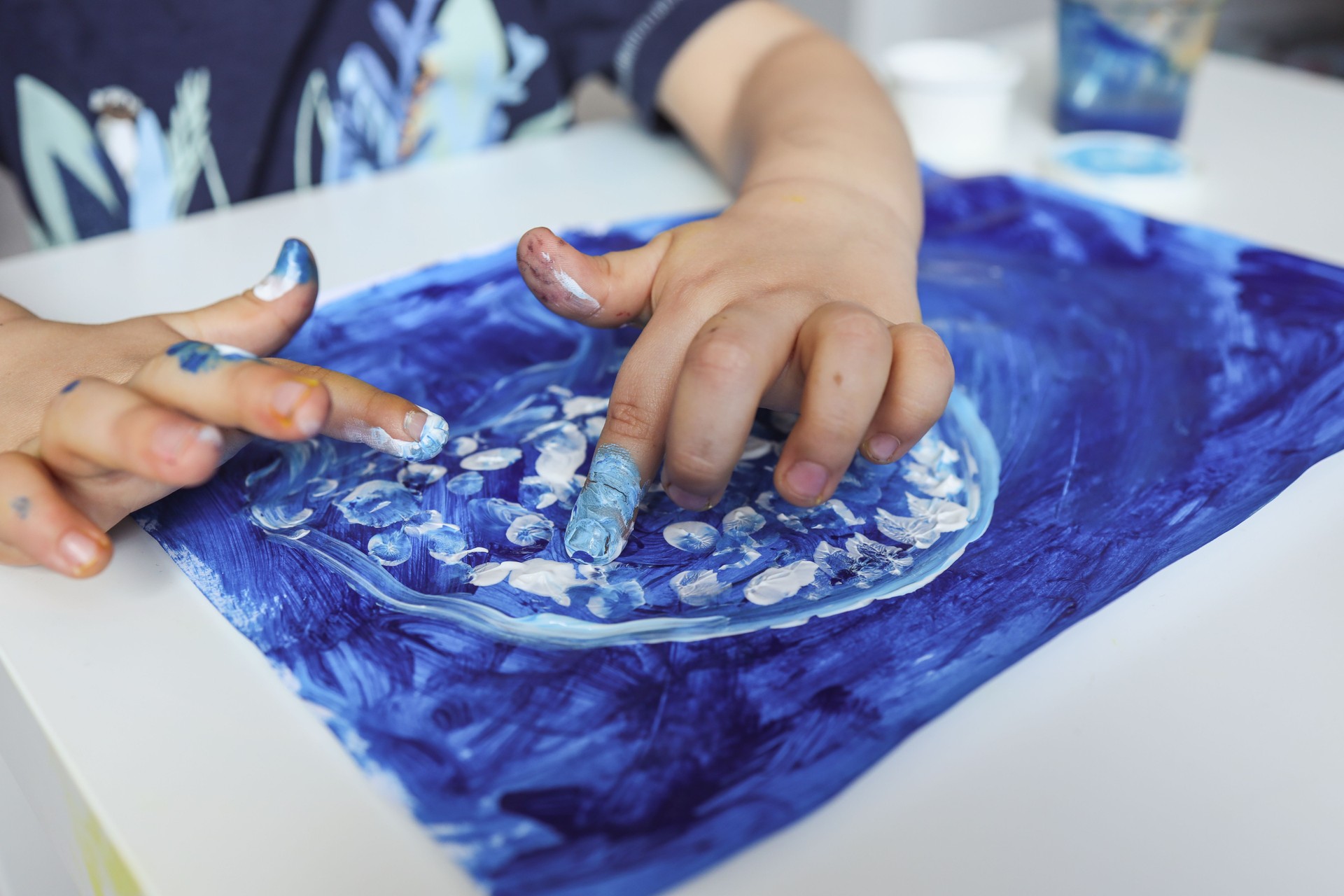 Finger painting. Close-up. Fingers of children's hands in bright paint. Early development. Hobby